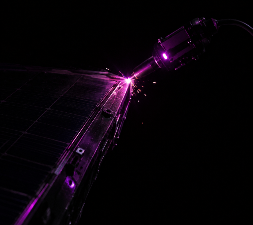 A robotic arm fitted with a compact electron-beam welding tool repairs the hull of a damaged satellite, backlit by low golden sunlight with Earth visible below.